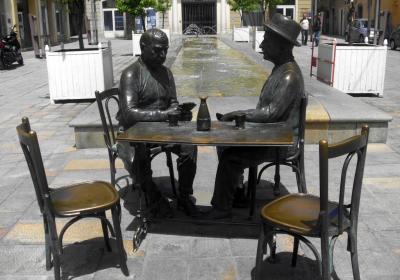 Statue Of Men Playing Cards